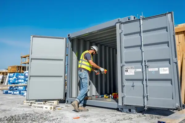 Contractor securing tools and job-site equipment in an on-site storage container